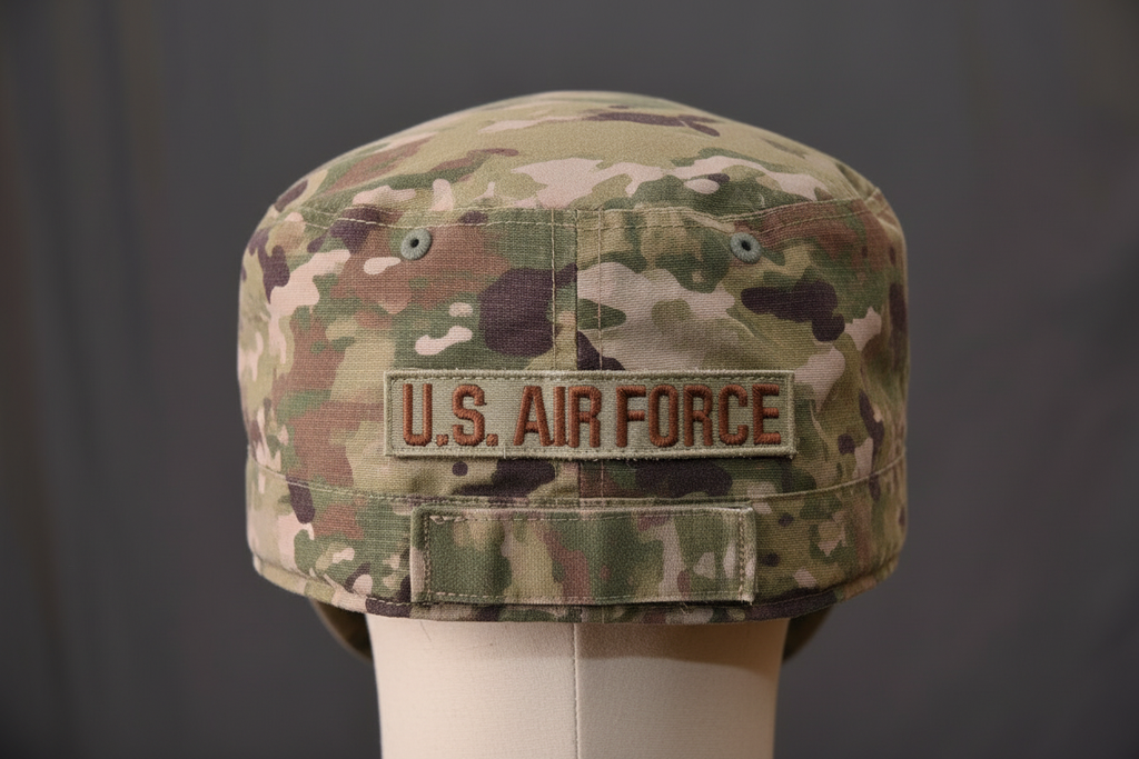 Back of OCP MultiCam patrol cap with U.S. Air Force name tape in Spice Brown embroidery on tan background, showing hook fastener attachment on military camouflage hat