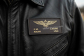 Custom handcrafted US Navy badges on brown leather with personalized text and durable finish