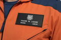 Pair of custom USCG black leather badges with personalized engraved text